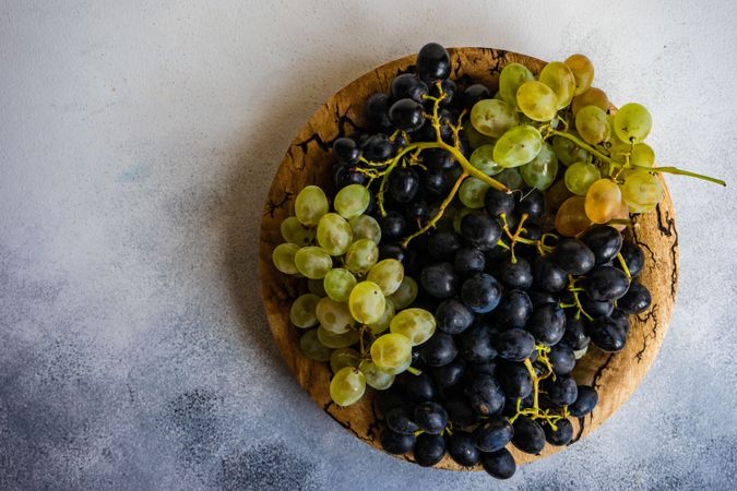 Top view of grapes on rustic plate