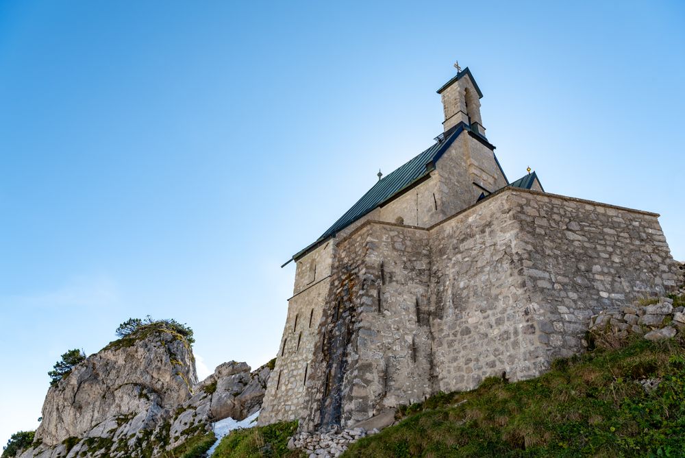 Stone church on a mountaintop in the Bavarian Alps on a sunny day in summer