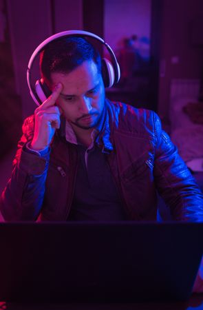 Man listening cheerfully to music with headphones.
