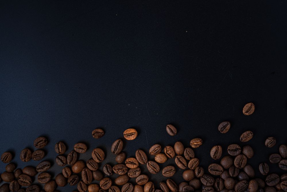 Scattered coffee beans on the side