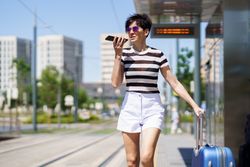 Woman speaking on phone while waiting for train