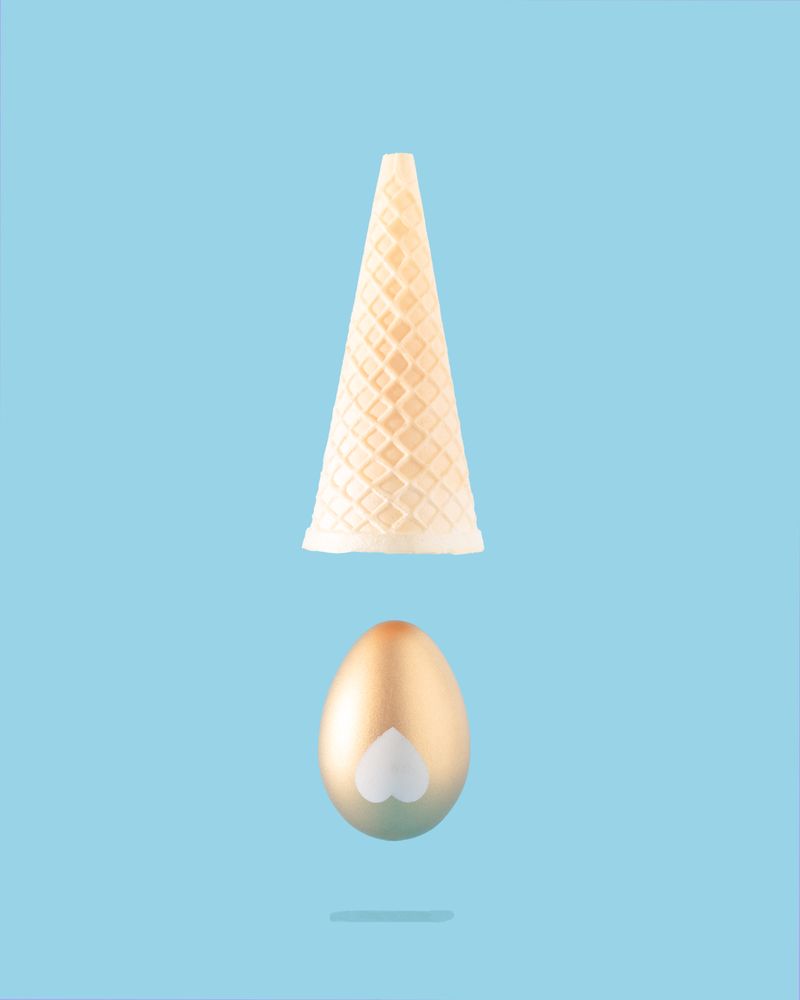 Gold egg with upside down ice cream cone above
