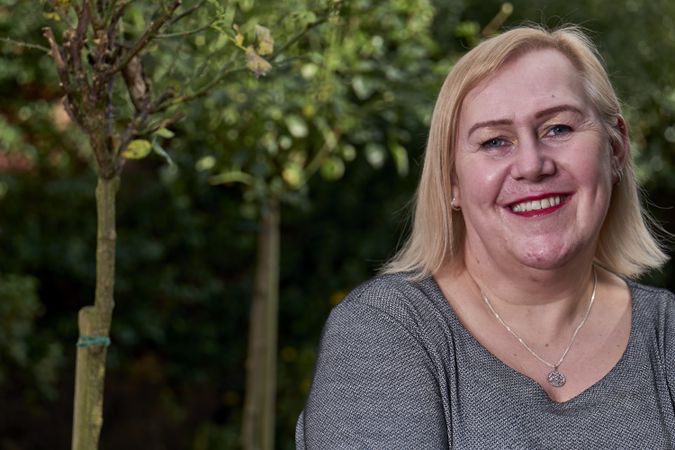 Portrait of happy woman standing in garden