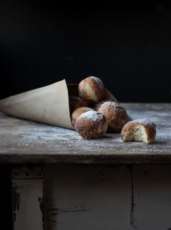 Baked cakes in craft paper on table
