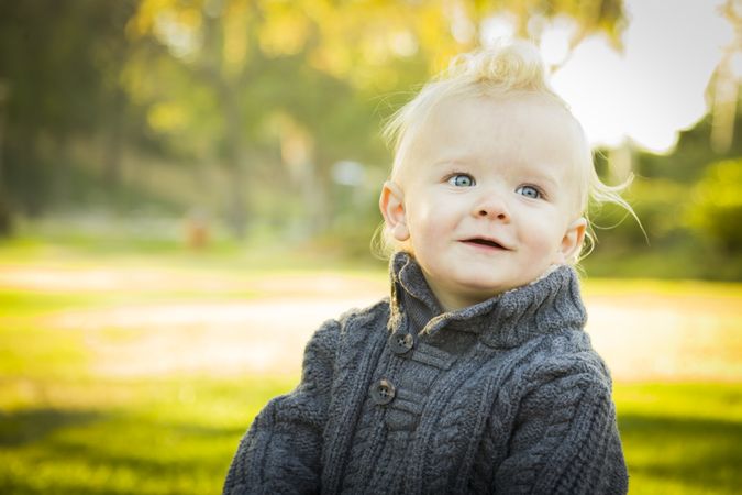 Adorable Blonde Baby Boy Outdoors at the Park.