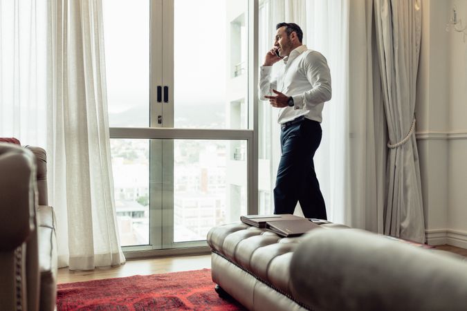 Businessman making phone call from hotel room