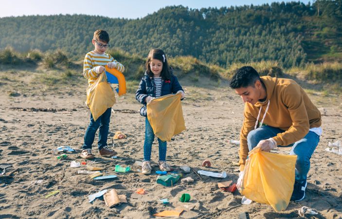 Young volunteers cleaning the beach