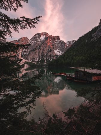 Houseboat surrounded with mountains on serene lake