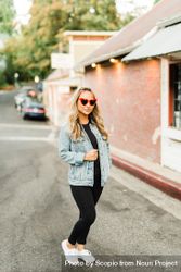 Woman with sunglasses standing on road 0gMpe4