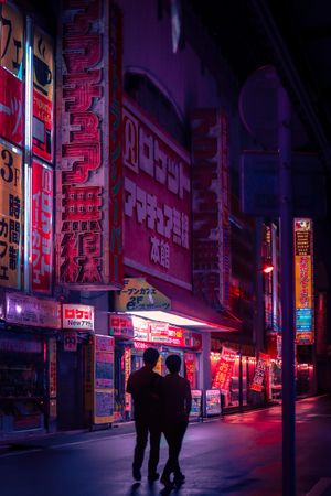 Silhouette of two people walking down the street in Japan