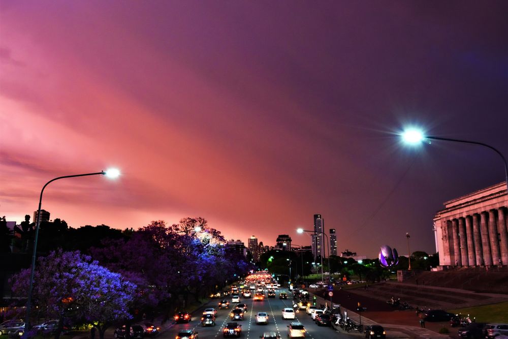 View of busy road with colorful sunset