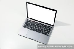 Opened silver laptop at angle with mockup screen on desk 5oJ3z0