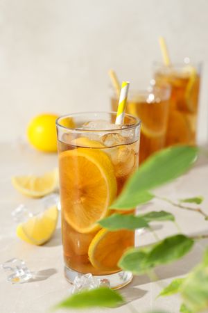 A glass of cold tea with fresh orange slices