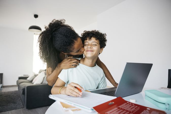 Girl doing her homework with mother