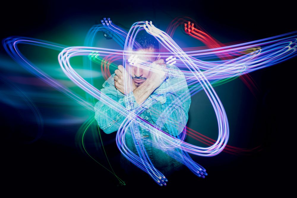 bearded man dancing in spotlight
