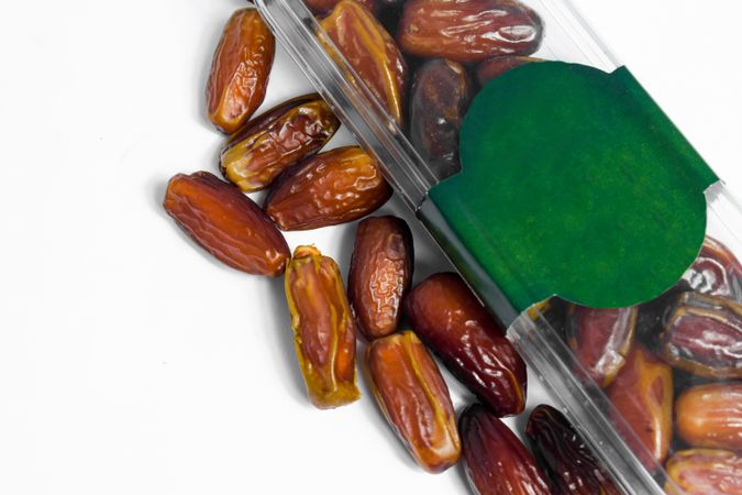 Dates fruit in plastic package with blank green label for product mockup design