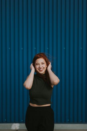 Smiling woman squinting in sun and enjoying weather