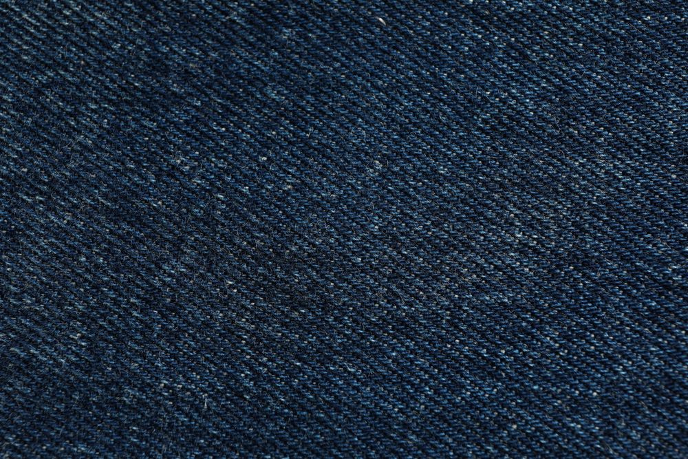Texture of blue jeans as background, space for text