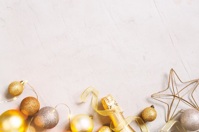 Christmas baubles and champagne on light background with copy space