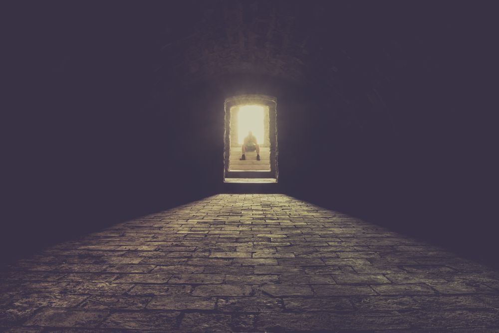 Man sitting on basement stairs