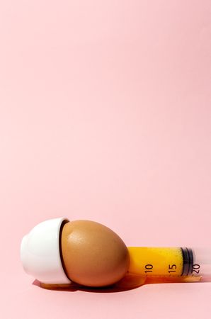 Egg with syringe in eggcup