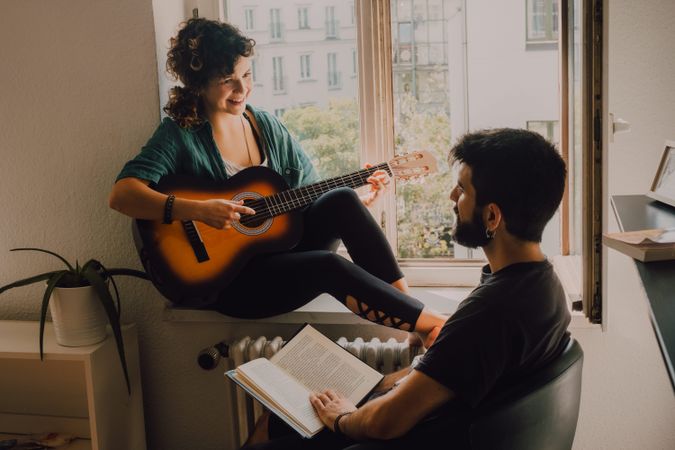 Cheerful couple spending time together at home