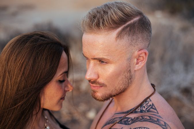 Cool dreamy couple in swimwear on shore
