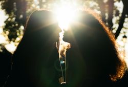 silhouette of two women kissing in the sunlight