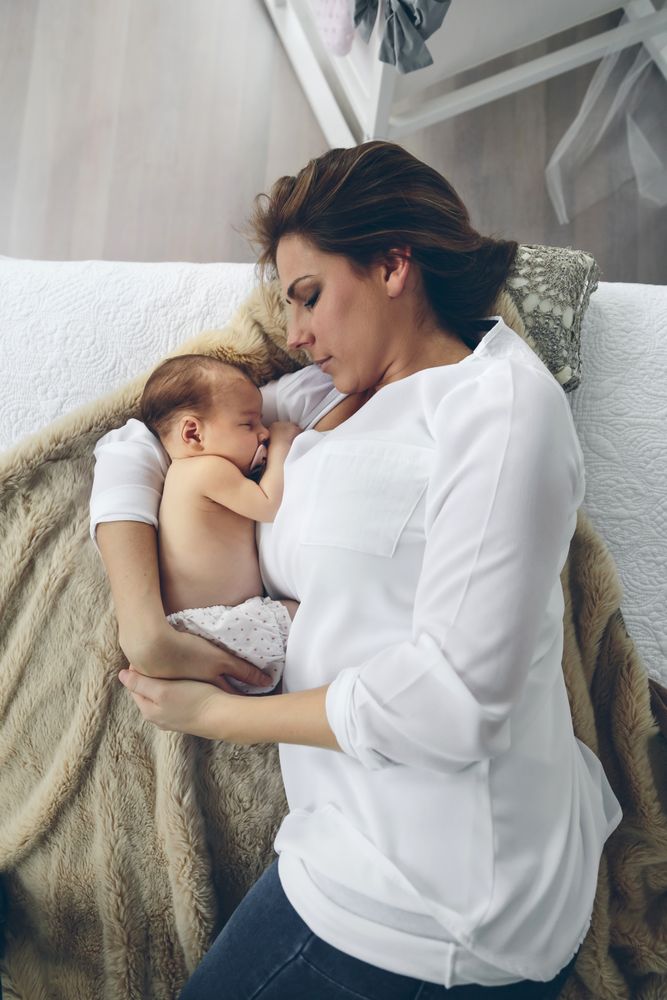 Mother hugging her newborn baby girl
