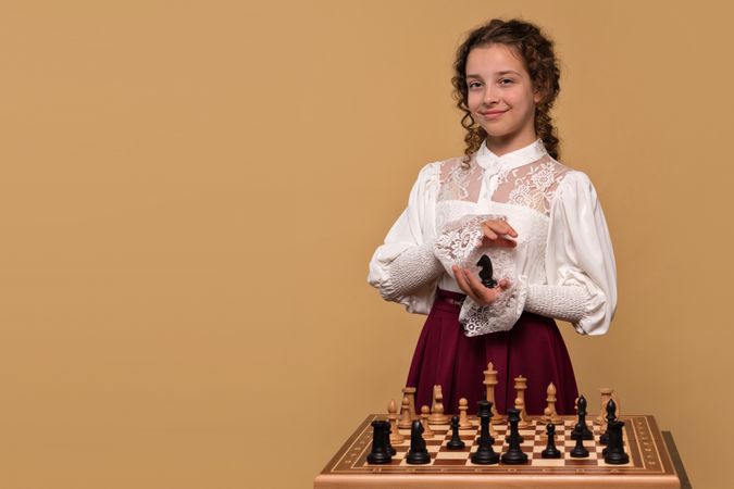 Young girl holding chess knight