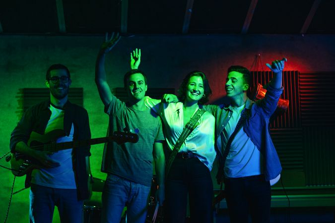 Musicians In Stage With Colorful Lights Performing In A Live Concert