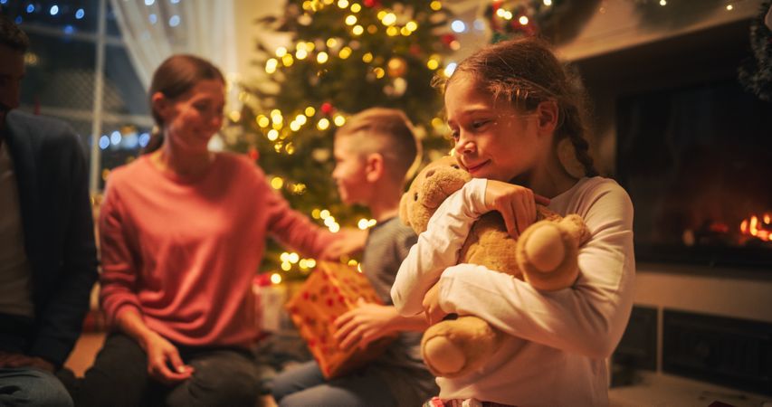 Loving Young Parents Giving Gifts to Their Children on Christmas Eve.
