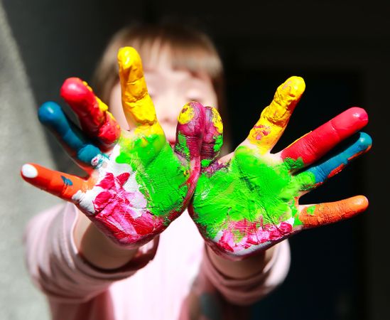Close up of two colorful painted hands
