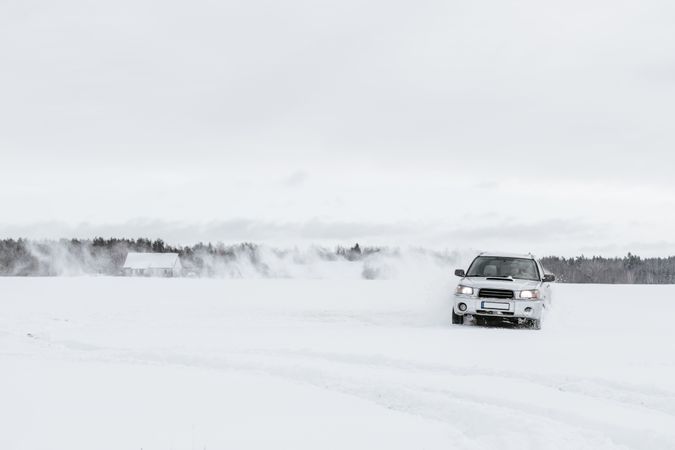 Car driving on snow field
