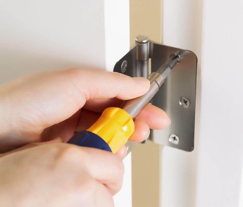 Fixing door hinge with Screwdriver