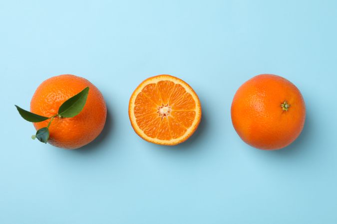 Ripe sweet mandarins on blue background, top view