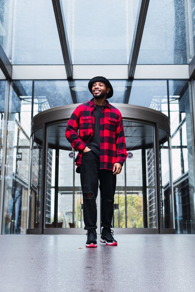 Positive man near glass building entrance