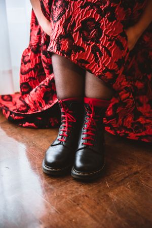 Woman in dress lacing boots