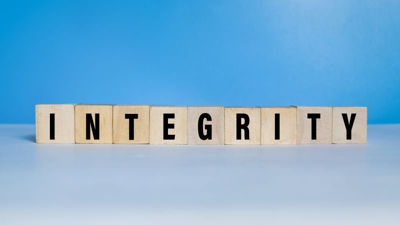 integrity word text on wooden blocks on blue background