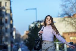 Woman in casual wear laughing on a sunny day