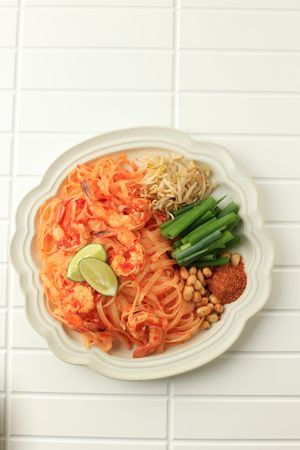 Top view of spicy pad Thai on tiled table
