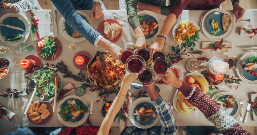 Parents, Children and Friends Enjoying Christmas Dinner Together in a Cozy Home.