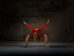 Young woman dancing in darkness