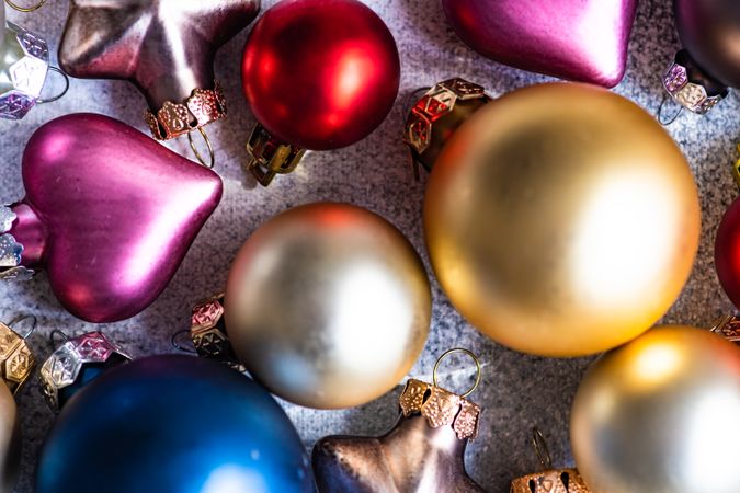 Close up of Christmas card concept of colorful baubles on concrete counter