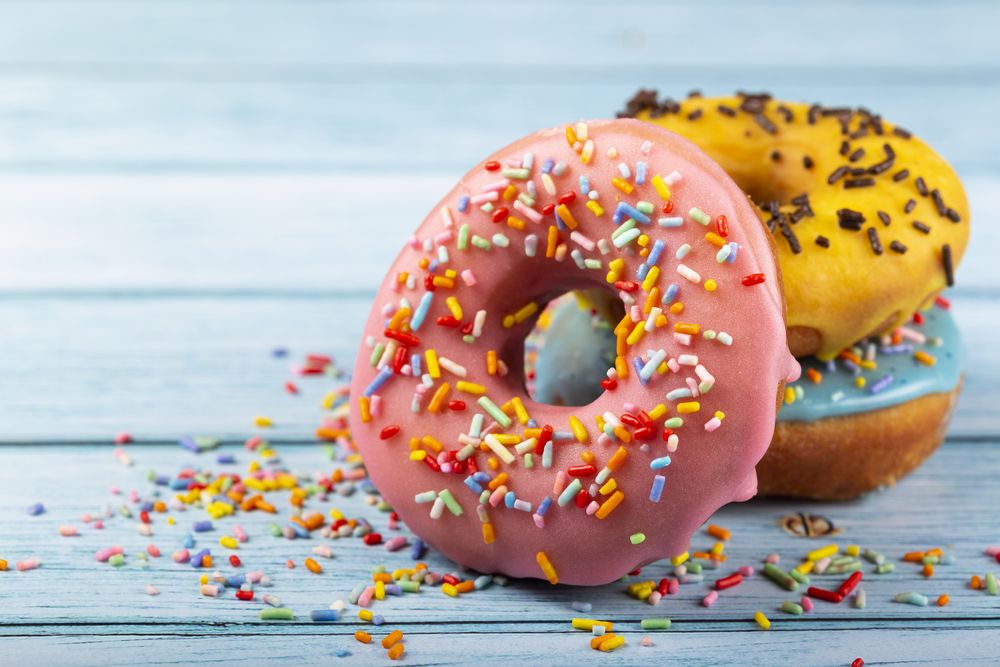 Delicious assorted colorful donuts on the table.