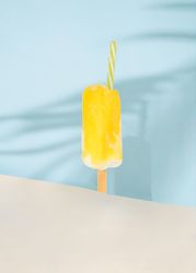 Ice cream pop with party cocktail straw.