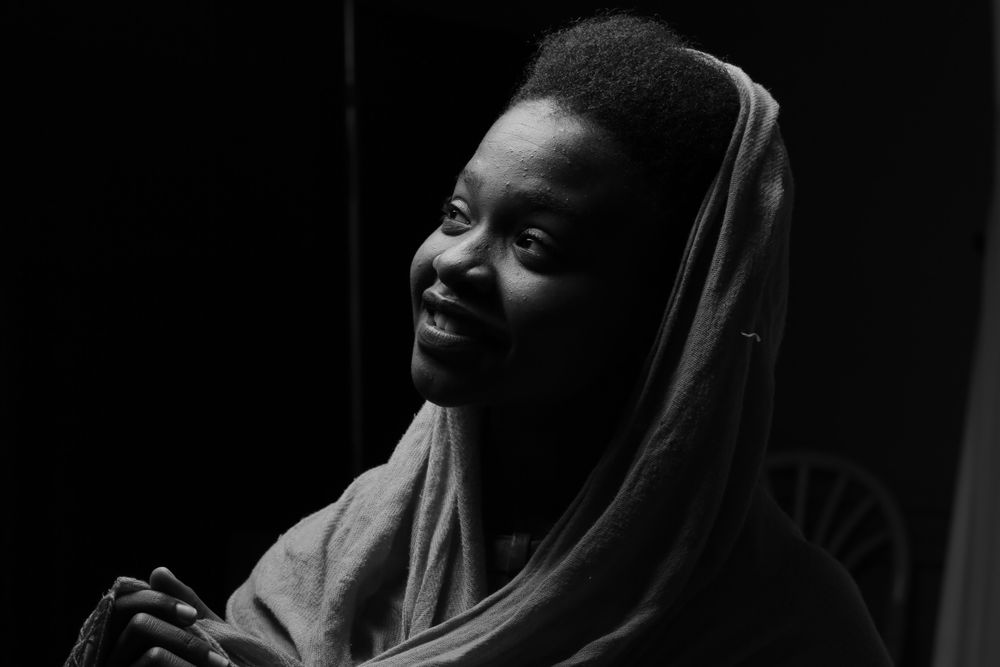 Portrait of smiling woman wearing veil in grayscale