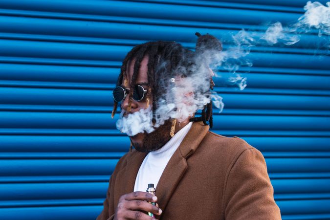 Hipster Black man with electronic cigarette