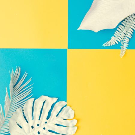 Painted tropical and palm leaves on cyan and yellow background