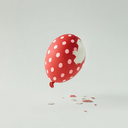 Polka dot red Easter egg balloon on bright light  background